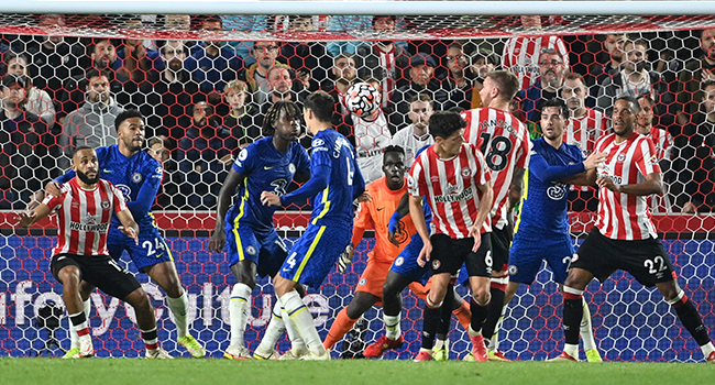 Chelsea's French-born Senegalese goalkeeper Edouard Mendy (C) keeps an eye on the ball as it pings around his goal mouth during a period of Brentford pressure toward the end of the English Premier League football match between Brentford and Chelsea at Brentford Community Stadium in London on October 16, 2021. JUSTIN TALLIS / AFP