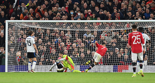 Manchester United's Portuguese striker Cristiano Ronaldo (3R) scores his team's third goal during the UEFA Champions league group F football match between Manchester United and Atalanta at Old Trafford stadium in Manchester, north west England, on October 20, 2021. Paul ELLIS / AFP