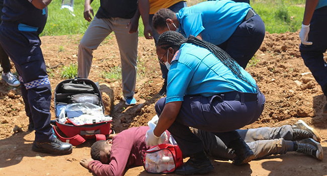 Paramedics tend to a person who was injured by police during protests in Mbabane on October 20, 2021. AFP