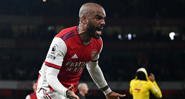 Arsenal's French striker Alexandre Lacazette celebrates scoring his team's second goal with Arsenal's Ghanaian midfielder Thomas Partey during the English Premier League football match between Arsenal and Crystal Palace at the Emirates Stadium in London on October 18, 2021. Glyn KIRK / AFP