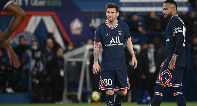 Paris Saint-Germain's Argentinian forward Lionel Messi (L) and Paris Saint-Germain's Brazilian forward Neymar react during the French L1 football match between Paris Saint-Germain (PSG) and LOSC Lille at the Parc des Princes stadium, in Paris, on October 29, 2021. FRANCK FIFE / AFP