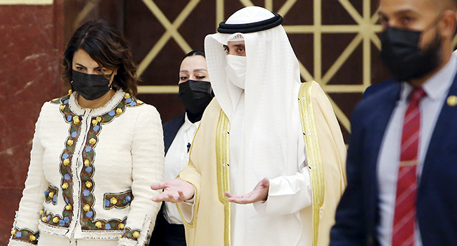 Libyan Foreign Minister Najla al-Mangoush (L) and her Kuwaiti counterpart Ahmad Nasser Mohammad al-Sabah arrive for a joint press conference in Kuwait City on October 3, 2021. YASSER AL-ZAYYAT / AFP