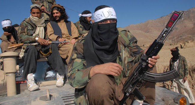 In this file photo taken on November 26, 2008, Pakistan's Taliban commander Latif Mehsud (C), a close aide to the former chief of the Tehreek-e-Taliban Pakistan (TTP), Hakimullah Mehsud, sits on a harmed vehicle in Mamouzai area