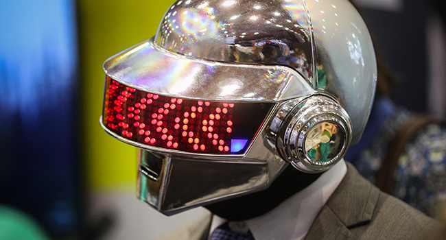 An attendee wearing a Daft Punk helmet and gloves take part in the Web Summit in Lisbon on November 2, 2021. CARLOS COSTA / AFP