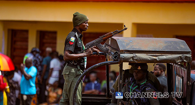 A police officer wields a gun at a polling unit on November 6, 2021. Sodiq Adelakun/Channels Television