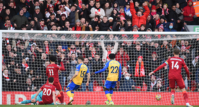 Liverpool's Portuguese striker Diogo Jota (L) scores the opening goal of the English Premier League football match between Liverpool and Southampton at Anfield in Liverpool, north west England on November 27, 2021. Oli SCARFF / AFP