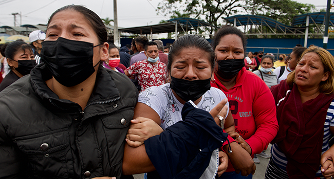 Relatives of inmates cry as they wait for news about their loved ones after 58 convicts were killed in a riot at the Guayas 1 prison in Guayaquil, Ecuador, on November 13, 2021. Fernando Mendez / AFP