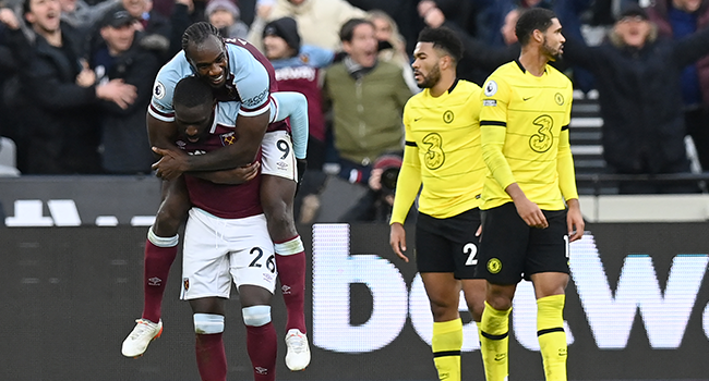 West Ham United's French defender Arthur Masuaku (L) celebrates with West Ham United's English midfielder Michail Antonio after he scores his team's third goal during the English Premier League football match between West Ham United and Chelsea at The London Stadium, in east London on December 4, 2021. Glyn KIRK / AFP