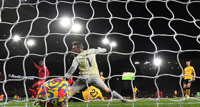 Liverpool's Belgium striker Divock Origi (L) scores his team's opening goal during the English Premier League football match between Wolverhampton Wanderers and Liverpool at the Molineux stadium in Wolverhampton, central England on December 4, 2021. JUSTIN TALLIS / AFP