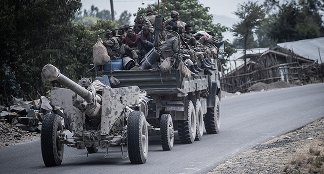Members of the Ethiopian National Defense Force (ENDF) are seen on a truck as they transport a Saeer KS-19 automatic 100mm anti aircraft gun in Shewa Robit, Ethiopia, on December 05, 2021. Amanuel Sileshi / AFP