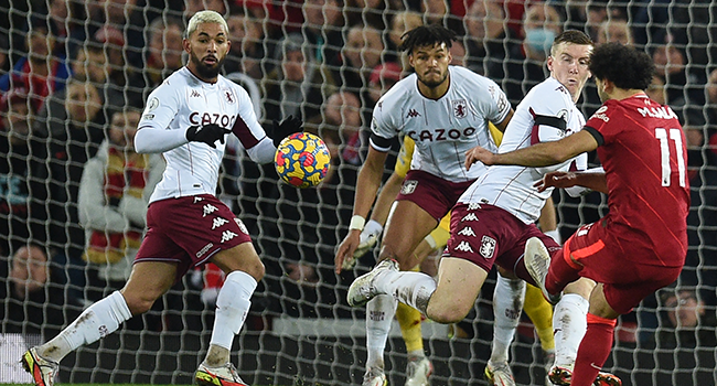 Liverpool's Egyptian midfielder Mohamed Salah (R) misses a chance during the English Premier League football match between Liverpool and Aston Villa at Anfield in Liverpool, north west England on December 11, 2021. Oli SCARFF / AFP