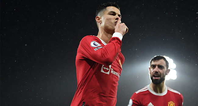 Manchester United's Portuguese striker Cristiano Ronaldo celebrates after scoring the opening goal from the penalty spot during the English Premier League football match between Norwich City and Manchester United at Carrow Road Stadium in Norwich, eastern England, on December 11, 2021. Daniel LEAL / AFP