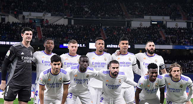 In this file photo taken on December 12, 2021 Real Madrid's team players pose prior to the Spanish league football match between Real Madrid CF and Club Atletico de Madrid at the Santiago Bernabeu stadium in Madrid. JAVIER SORIANO / AFP