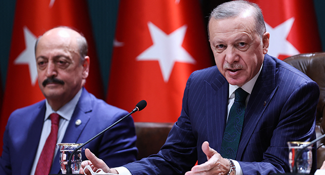 Turkish President Recep Tayyip Erdogan (R) speaks to announce the net minimum wage will be raised by 50 percent starting next year, next to Turkish Minister of Labor and Social Security Vedat Bilgin at the Presidential Complex in Ankara, Turkey on December 16, 2021. Adem ALTAN / AFP