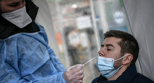 A patient is tested for the novel coronavirus Covid-19 in Paris on December 23, 2021. STEPHANE DE SAKUTIN / AFP