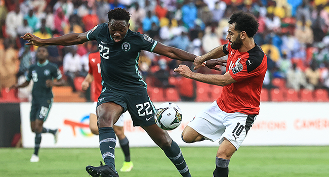 Egypt's forward Mohamed Salah (R) fights for the ball with Nigeria's defender Kenneth Omeruo during the Group D Africa Cup of Nations (CAN) 2021 football match between Nigeria and Egypt at Stade Roumde Adjia in Garoua on January 11, 2022. Daniel BELOUMOU OLOMO / AFP