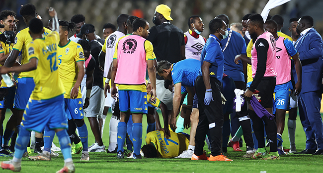 Gabon's forward Aaron Boupendza (down) lies on the ground after being punched by Ghana's forward Benjamin Tetteh (unseen) in a scuffle at the end of the during the Group C Africa Cup of Nations (CAN) 2021 football match between Gabon and Ghana at Stade Ahmadou Ahidjo in Yaounde on January 14, 2022. Kenzo Tribouillard / AFP