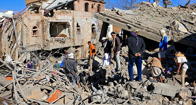 Yemenis inspect the damage following overnight air strikes by the Saudi-led coalition targeting the Huthi rebel-held capital Sanaa, on January 18, 2022. MOHAMMED HUWAIS / AFP