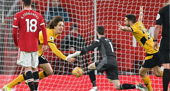 Wolverhampton Wanderers' Portuguese midfielder Joao Moutinho (R) celebrates after scoring the opening goal of the English Premier League football match between Manchester United and Wolverhampton Wanderers at Old Trafford in Manchester, north west England, on January 3, 2022. Paul ELLIS / AFP