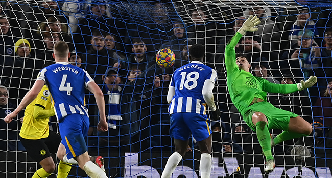 Brighton's English defender Adam Webster (L) starts to celebrate as his header beats Chelsea's Spanish goalkeeper Kepa Arrizabalaga (R) for their first goal during the English Premier League football match between Brighton and Hove Albion and Chelsea at the American Express Community Stadium in Brighton, southern England on January 18, 2022. Glyn KIRK / AFP