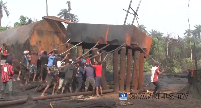 Men at work during the demolition of an illegal refinery in Rivers State.