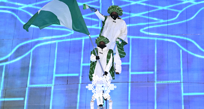 Nigeria's flag bearer leads the delegation as they enter the stadium during the opening ceremony of the Beijing 2022 Winter Olympic Games, at the National Stadium, known as the Bird's Nest, in Beijing, on February 4, 2022. Jewel SAMAD / AFP