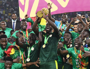 Senegal's players celebrate with the trophy after winning the Africa Cup of Nations (CAN) 2021 final football match between Senegal and Egypt at Stade d'Olembe in Yaounde on February 6, 2022. CHARLY TRIBALLEAU / AFP