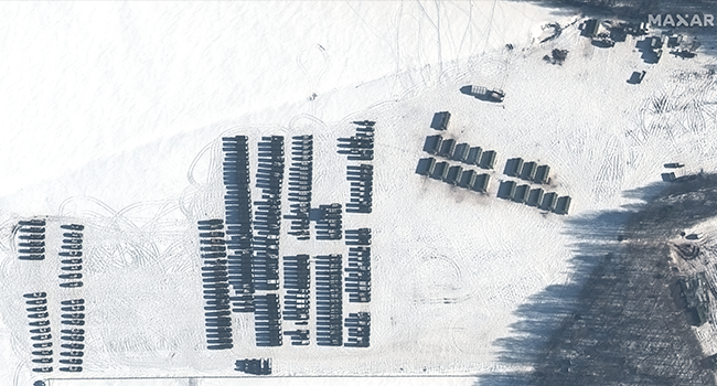 This handout satellite image released by Maxar Technologies shows troops and logistics material support units positioned northwest of Yelsk, Belarus, on February 4, 2022. Satellite image ©2022 Maxar Technologies / AFP
