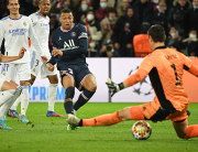 Paris Saint-Germain's French forward Kylian Mbappe (C) shoots and scores a goal during the UEFA Champions League round of 16 first leg football match between Paris Saint-Germain (PSG) and Real Madrid at the Parc des Princes stadium in Paris on February 15, 2022. Alain JOCARD / AFP