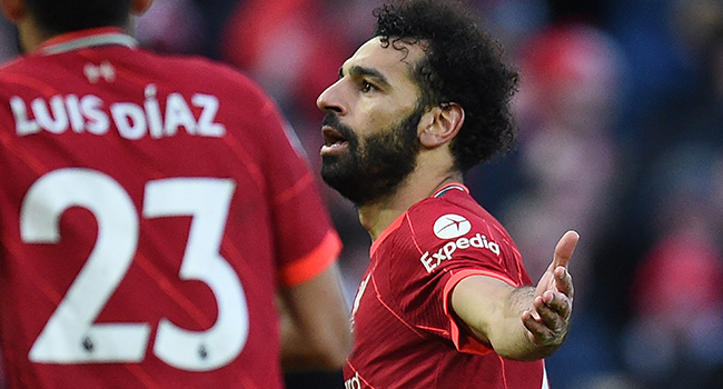 Liverpool's Egyptian midfielder Mohamed Salah celebrates after scoring their second goal during the English Premier League football match between Liverpool and Norwich City at Anfield in Liverpool, north west England on February 19, 2022. Oli SCARFF / AFP