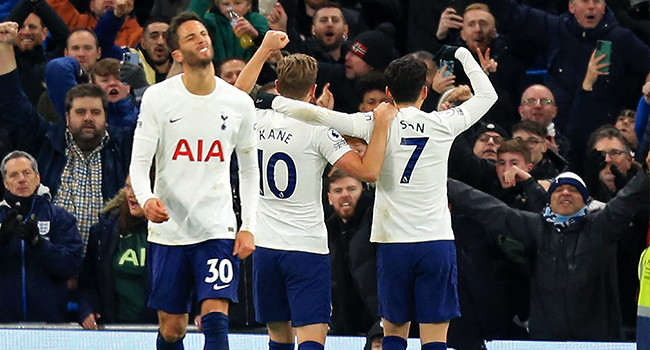 Tottenham Hotspur's English striker Harry Kane (C) and Tottenham Hotspur's South Korean striker Son Heung-Min (R) celebrate their second goal during the English Premier League football match between Manchester City and Tottenham Hotspur at the Etihad Stadium in Manchester, north west England, on February 19, 2022. Lindsey Parnaby / AFP