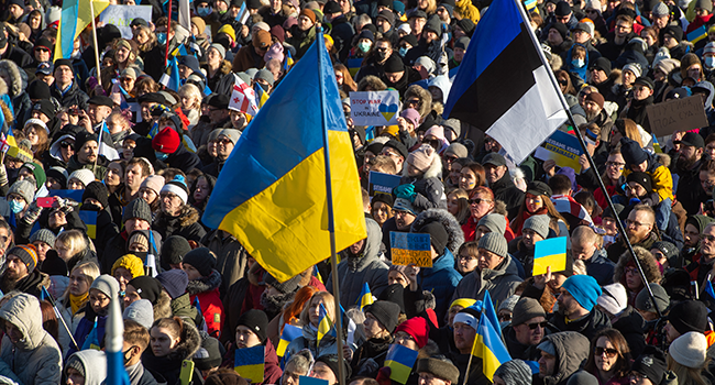 Protesters wave flags of Ukraine and Estonia as they take part in a demonstration in support of Ukraine on Freedom Square in Tallinn, Estonia, on February 26, 2022, following Russia's invasion of Ukraine. Raigo Pajula / AFP