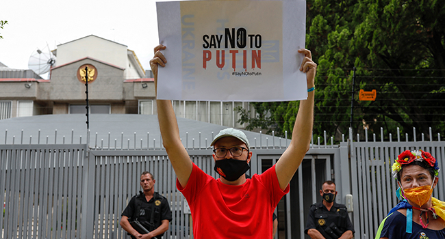 A member of South Africa's Ukrainian Association holds a during a protest in support of Ukraine in front of the Russian Embassy in Pretoria, on February 25, 2022. Phill Magakoe / AFP