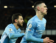 Manchester City's English midfielder Phil Foden (R) celebrates scoring his team's first goal with Manchester City's Portuguese midfielder Bernardo Silva (L) during the English Premier League football match between Everton and Manchester City at Goodison Park in Liverpool, north west England on February 26, 2022. Oli SCARFF / AFP