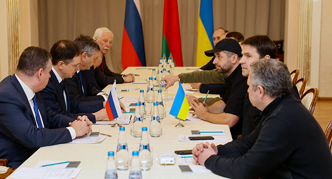 Members of delegations from Ukraine and Russia, including Russian presidential aide Vladimir Medinsky (2L), Ukrainian presidential aide Mykhailo Podolyak (2R), Volodymyr Zelensky's "Servant of the People" lawmaker Davyd Arakhamia (3R), hold talks in Belarus' Gomel region on February 28, 2022, following the Russian invasion of Ukraine. Sergei KHOLODILIN / BELTA / AFP