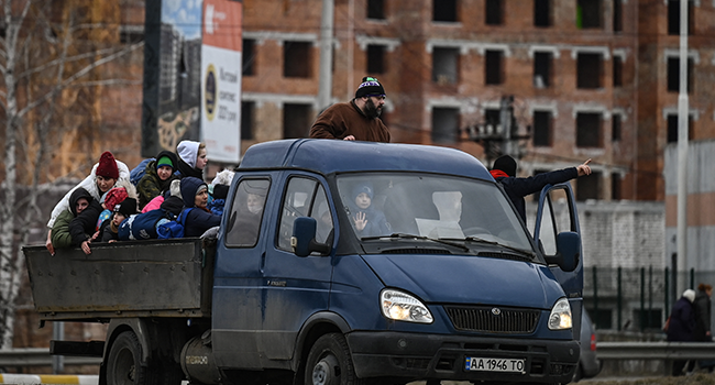 People sit in a car as as they evacuate the city of Irpin, northwest of Kyiv, during heavy shelling and bombing on March 5, 2022, 10 days after Russia launched a military in vasion on Ukraine. Aris Messinis / AFP