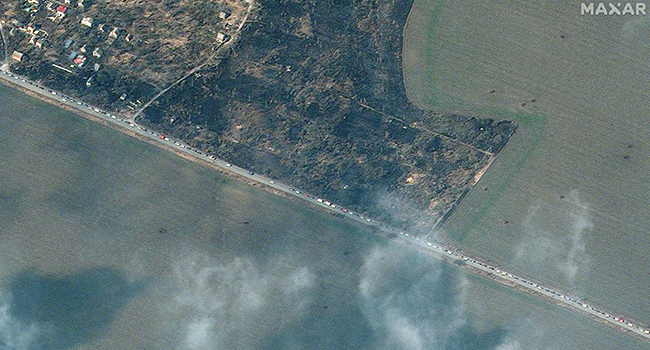 This handout picture taken and released by Maxar satelitte image on March 18, 2022 shows a part of a long line of cars with people evacuating from Mariupol, southeastern of Ukraine. AFP