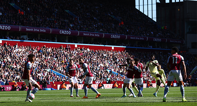 Arsenal's English midfielder Bukayo Saka (C-R back) scores a goal during the English Premier League football match between Aston Villa and Arsenal at Villa Park in Birmingham, central England, on March 19, 2022. Adrian DENNIS / AFP