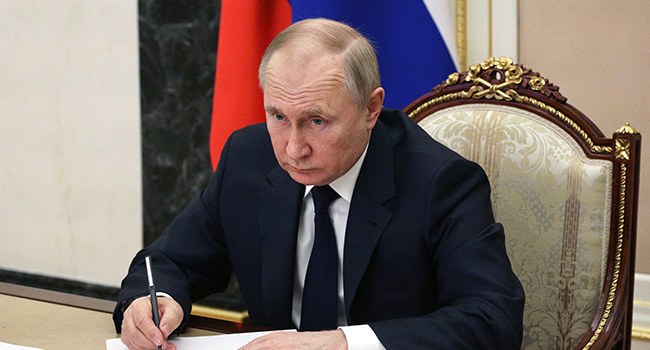 Russian President Vladimir Putin chairs a meeting with members of the Russian government via teleconference in Moscow on March 10, 2022. Mikhail Klimentyev / SPUTNIK / AFP