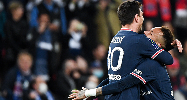 Paris Saint-Germain's Argentinian forward Lionel Messi (L) celebrates after opening the scoring with Paris Saint-Germain's Brazilian forward Neymar during the French L1 football match between Paris-Saint Germain (PSG) and Lens (RCL) at The Parc des Princes Stadium in Paris on April 23, 2022. Alain JOCARD / AFP