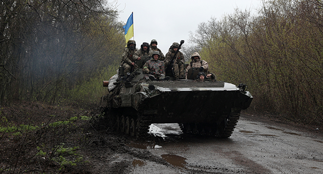 Ukrainian soldiers stand on an armoured personnel carrier (APC), not far from the front-line with Russian troops, in Izyum district, Kharkiv region on April 18, 2022, during the Russian invasion of Ukraine. Anatolii Stepanov / AFP