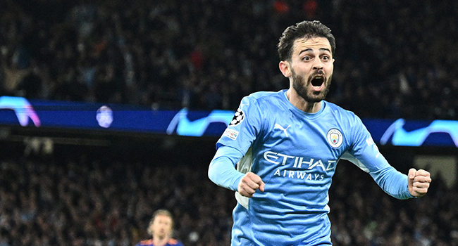 Manchester City's Portuguese midfielder Bernardo Silva celebrates after scoring his team fourth goal during the UEFA Champions League semi-final first leg football match between Manchester City and Real Madrid, at the Etihad Stadium, in Manchester, on April 26, 2022. Oli SCARFF / AFP