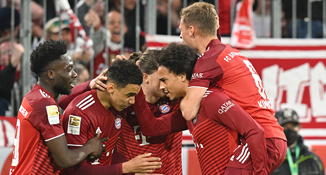 Bayern Munich's German midfielder Jamal Musiala (2nd L) celebrates scoring the 3-1 goal with his teammates during the German first division Bundesliga football match FC Bayern Munich v BVB Borussia Dortmund in Munich, southern Germany on April 23, 2022. KERSTIN JOENSSON / AFP