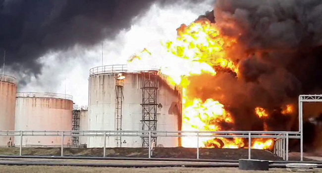 This video grab taken from a handout footage released by the Russian Emergencies Ministry on April 1, 2022 shows a Rosneft fuel depot on fire in the town of Belgorod, some 40 kilometres (25 miles) from Russia's border with Ukraine. Handout / Russian Emergencies Ministry / AFP