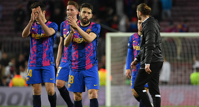 Barcelona's Spanish defender Jordi Alba and teammates react at the end of the Europa League quarter final second leg football match between FC Barcelona and Eintracht Frankfurt at the Camp Nou stadium in Barcelona on April 14, 2022. LLUIS GENE / AFP