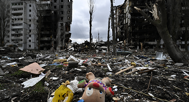 This photograph taken on April 6, 2022 shows a toy and personal belongings amongst rumbles in front of a destroyed residential building, in the town of Borodianka, northwest of Kyiv. Genya SAVILOV / AFP