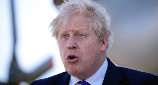 Britain's Prime Minister Boris Johnson reacts as he meets with HM Coastguard and Royal Navy crews and technical staff at Lydd Airport, in south east England, on April 14, 2022. Matt Dunham / POOL / AFP
