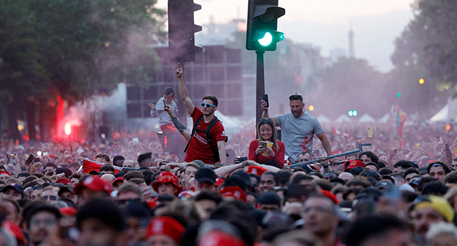 Liverpool FC's supporters light flares near Place de la Nation in Paris on May 28, 2022, prior to the Champions League football match final between Liverpool FC and Real Madrid. Geoffroy Van der Hasselt / AFP