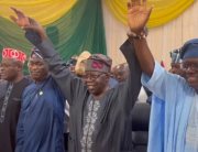 This screengrab from a video taken on May 6, 2022, shows Mr Tinubu holding up the hands of Lagos State Governor Babajide Sanwo-Olu and his Deputy Femi Hamzat.