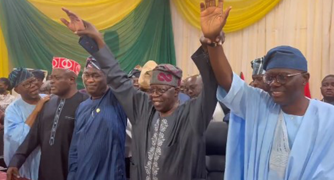 This screengrab from a video taken on May 6, 2022, shows Mr Tinubu holding up the hands of Lagos State Governor Babajide Sanwo-Olu and his Deputy Femi Hamzat.